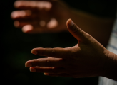 A person’s open hand inviting dialogue